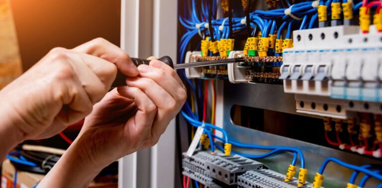 Electrician working on electrical panel wiring