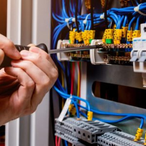Electrician working on circuit board wiring