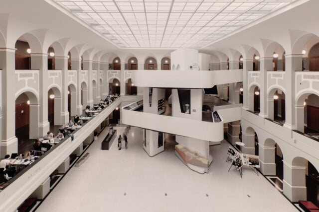 Modern library interior with balconies and workspaces.